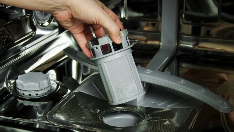 Accessing the filter in the base of the dishwasher (Image: Beko)